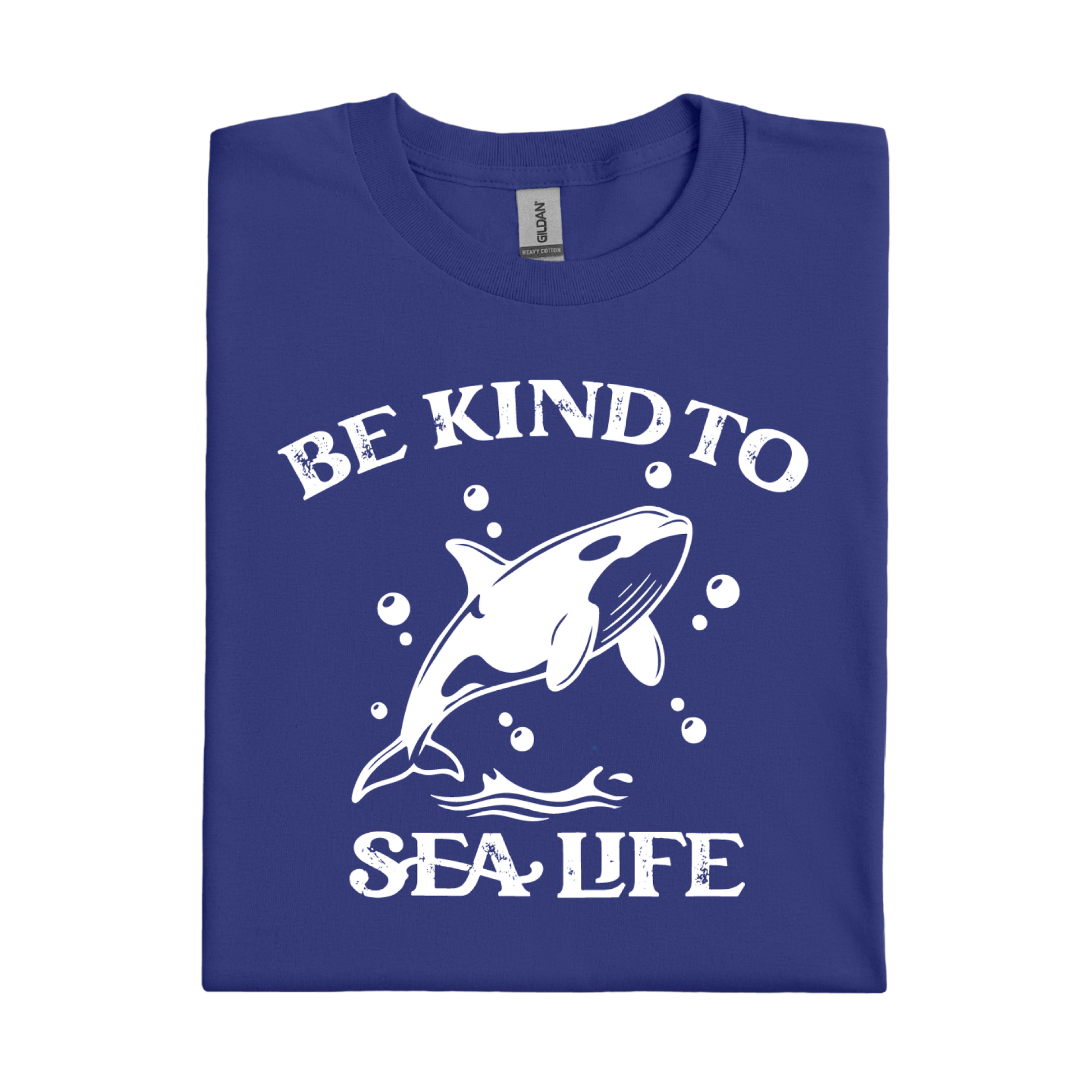 Folded cobalt blue t-shirt with white graphic of a whale and text 'Be Kind to Sea Life' on a white background