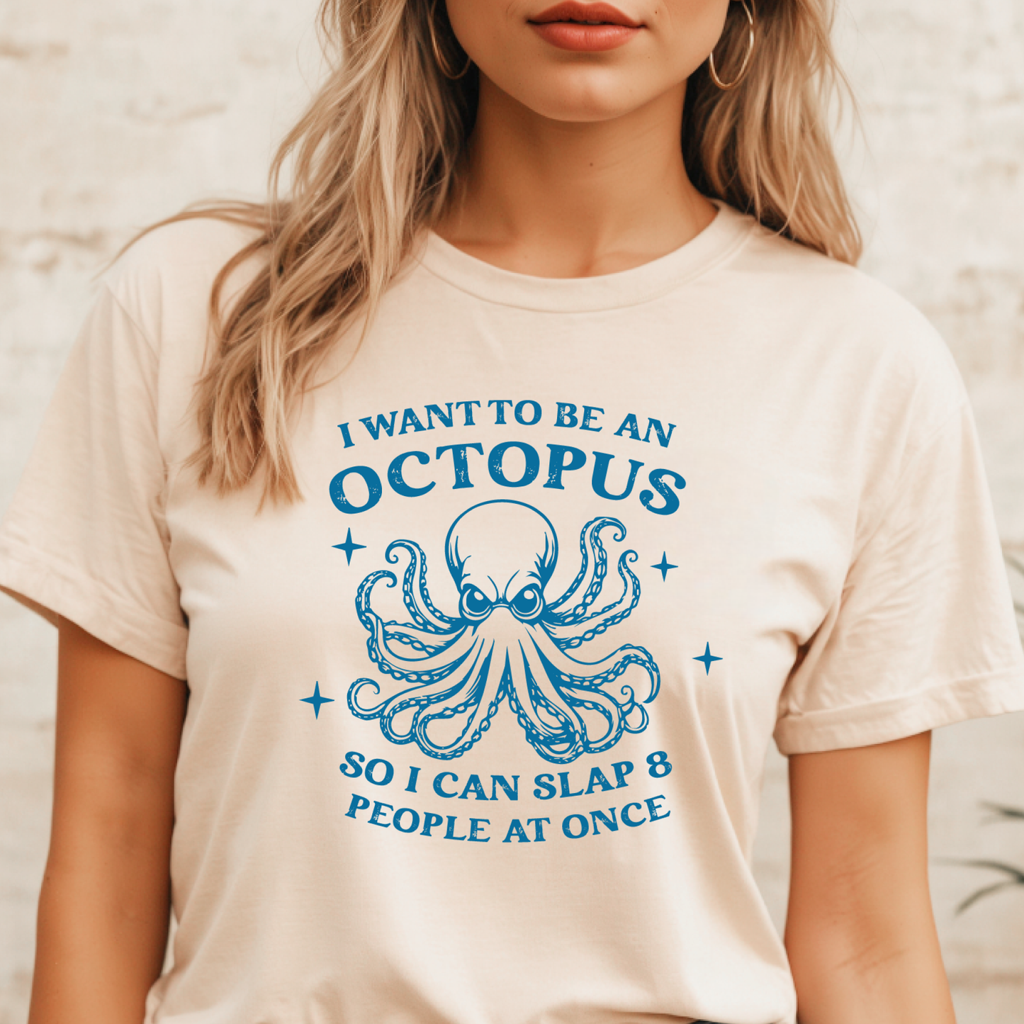Person wearing a t-shirt with an octopus graphic and text.