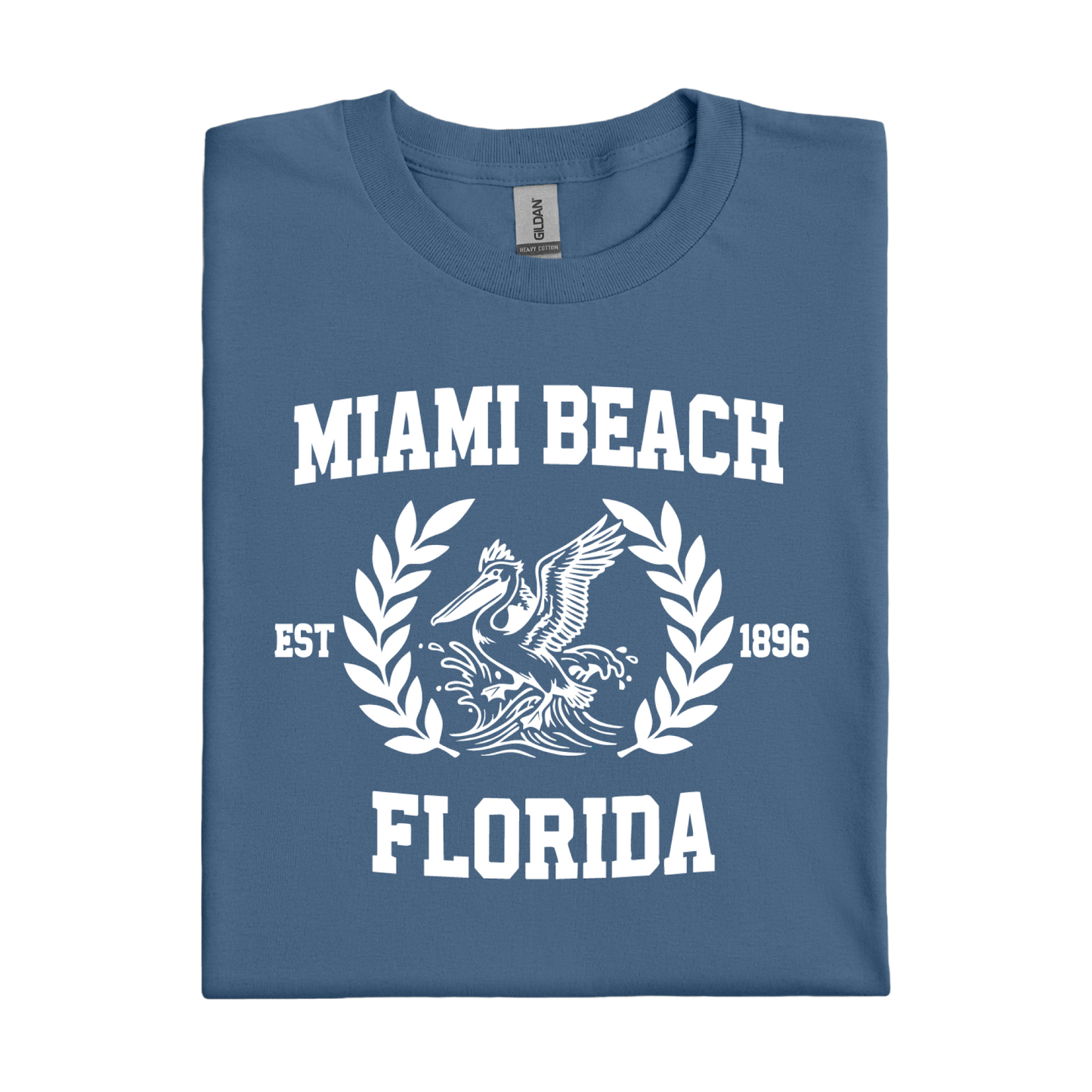 Folded indigo blue t-shirt with 'Miami Beach Florida' text and graphic on a white background
