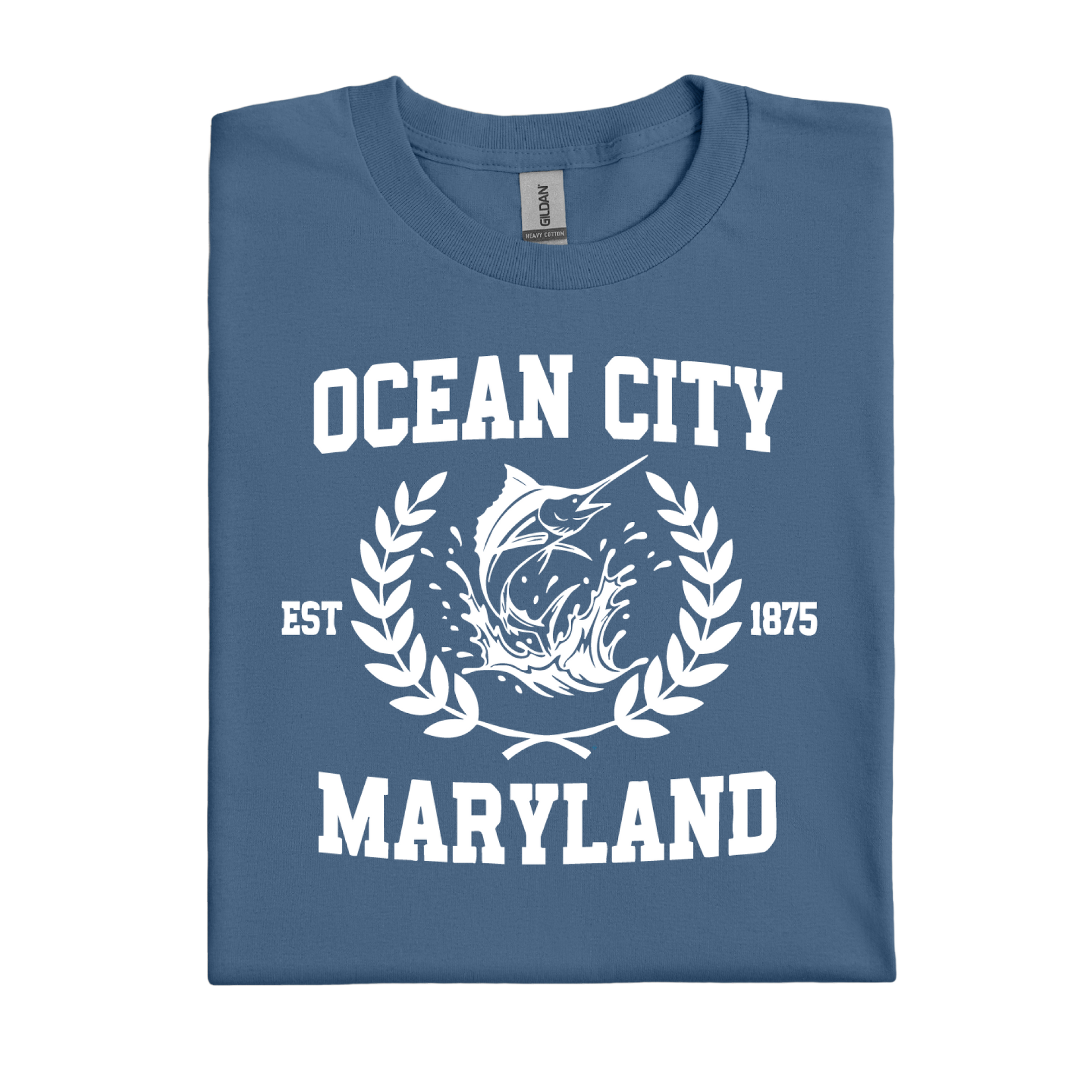 Folded indigo blue t-shirt with 'Ocean City, Maryland' text and fish graphic on a white background