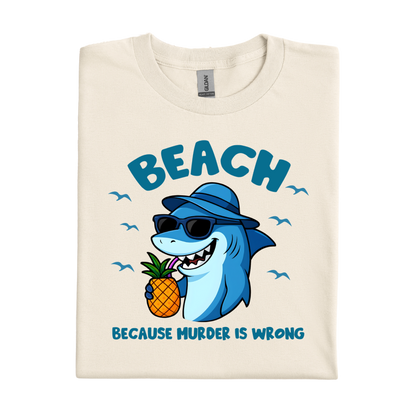 Beach-themed t-shirt with a cartoon shark holding a pineapple and text on a white background