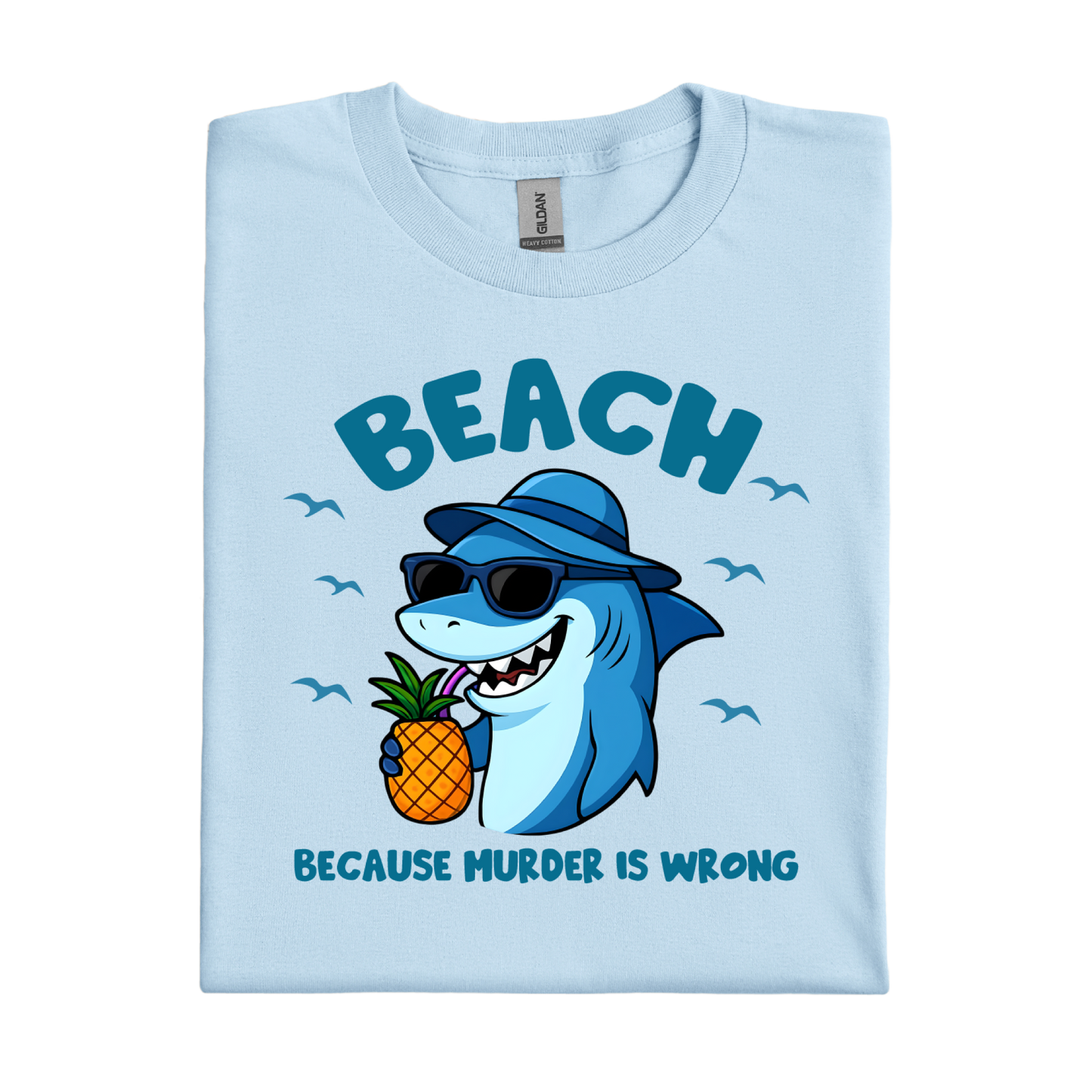Light blue t-shirt with a shark holding a pineapple and text on a white background