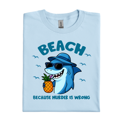 Light blue t-shirt with a shark holding a pineapple and text on a white background