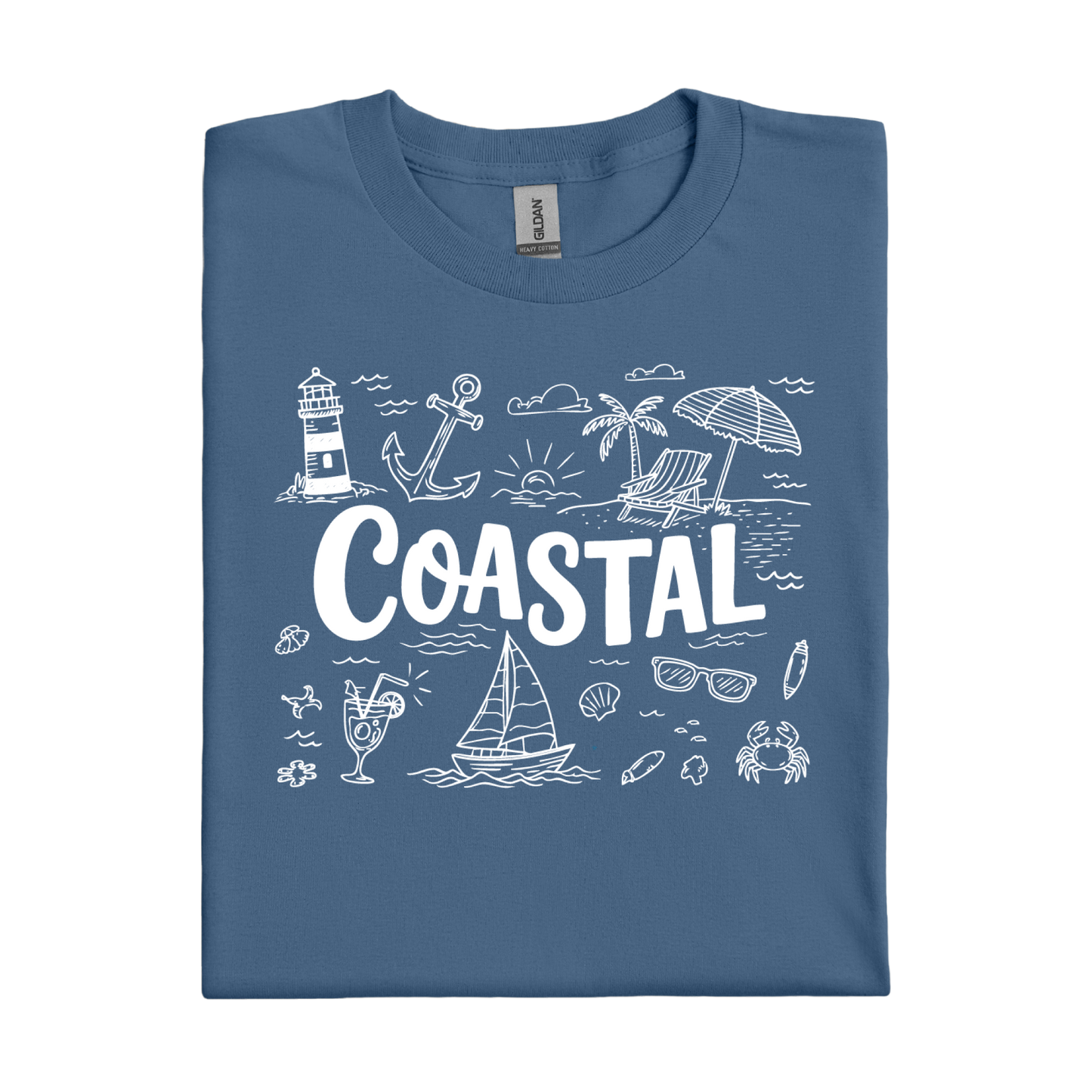 Folded indigo blue t-shirt with coastal-themed graphics and 'COASTAL' text on a white background