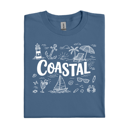 Folded indigo blue t-shirt with coastal-themed graphics and 'COASTAL' text on a white background
