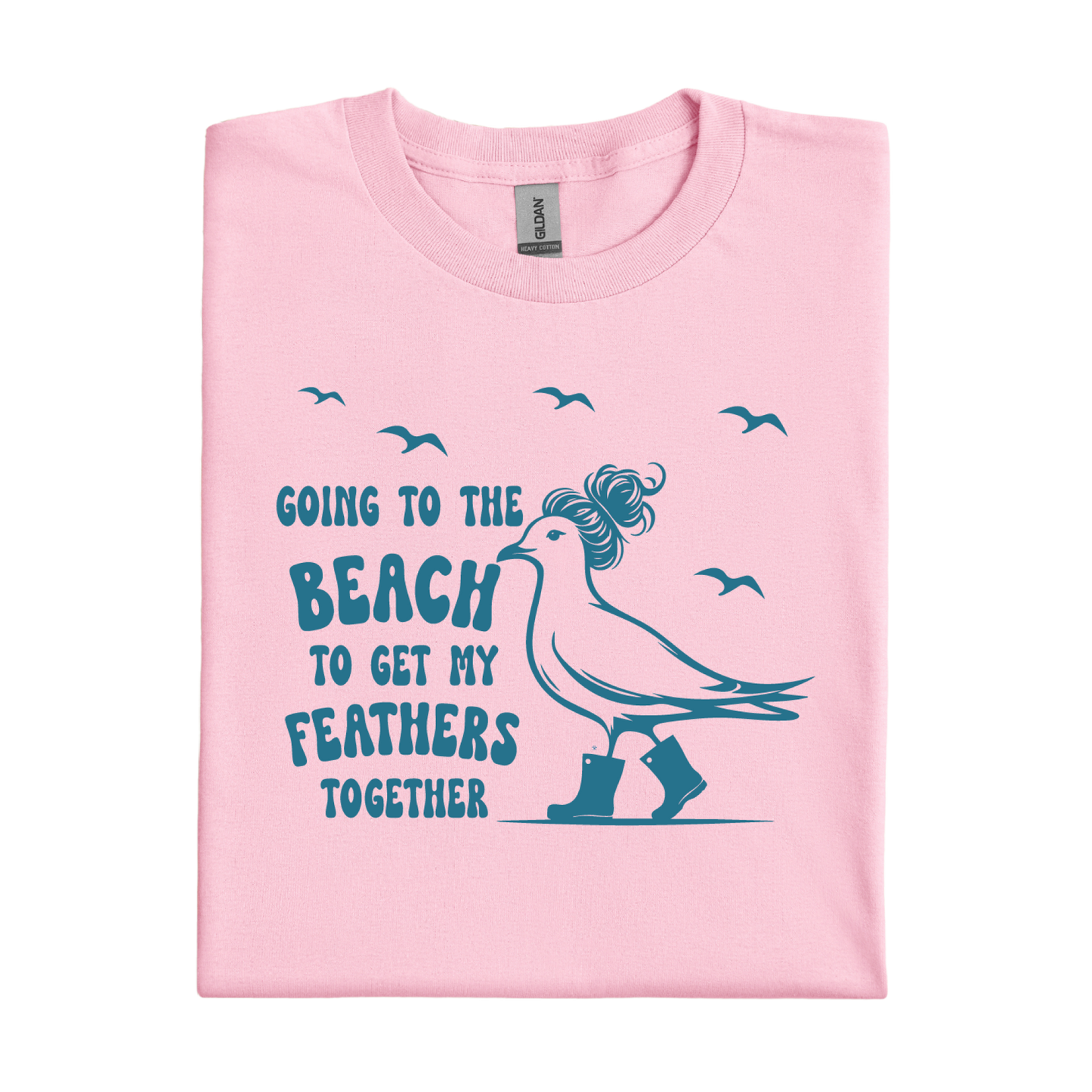 Light Pink t-shirt with a graphic of a bird and text 'Going to the beach to get my feathers together' on a white background.