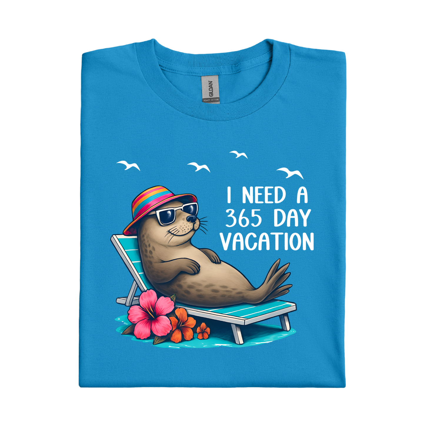 Sapphire Blue t-shirt with a seal character on a beach chair and text 'I Need a 365 Day Vacation' on a white background