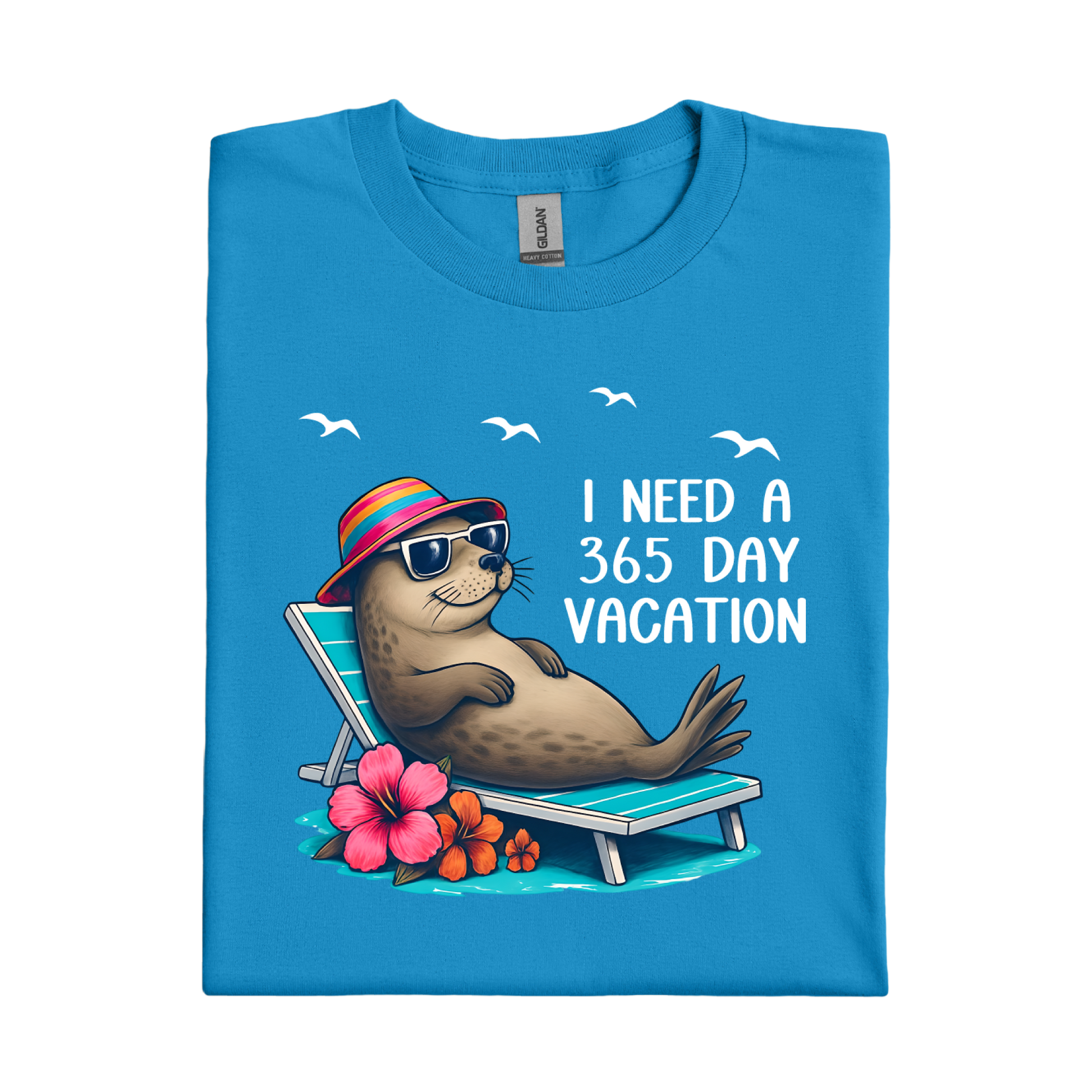 Sapphire Blue t-shirt with a seal character on a beach chair and text 'I Need a 365 Day Vacation' on a white background