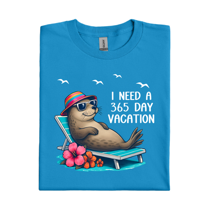 Sapphire Blue t-shirt with a seal character on a beach chair and text 'I Need a 365 Day Vacation' on a white background