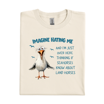 Natural t-shirt with a cartoon seagull and humorous text on a white background