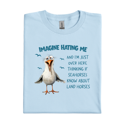 Light blue t-shirt with a cartoon seagull and humorous text on a white background