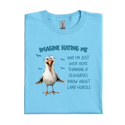 Sky blue t-shirt with a cartoon seagull and humorous text on a white background