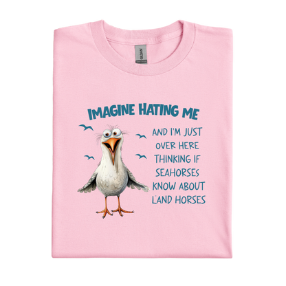Light Pink t-shirt with a cartoon seagull and humorous text on a white background