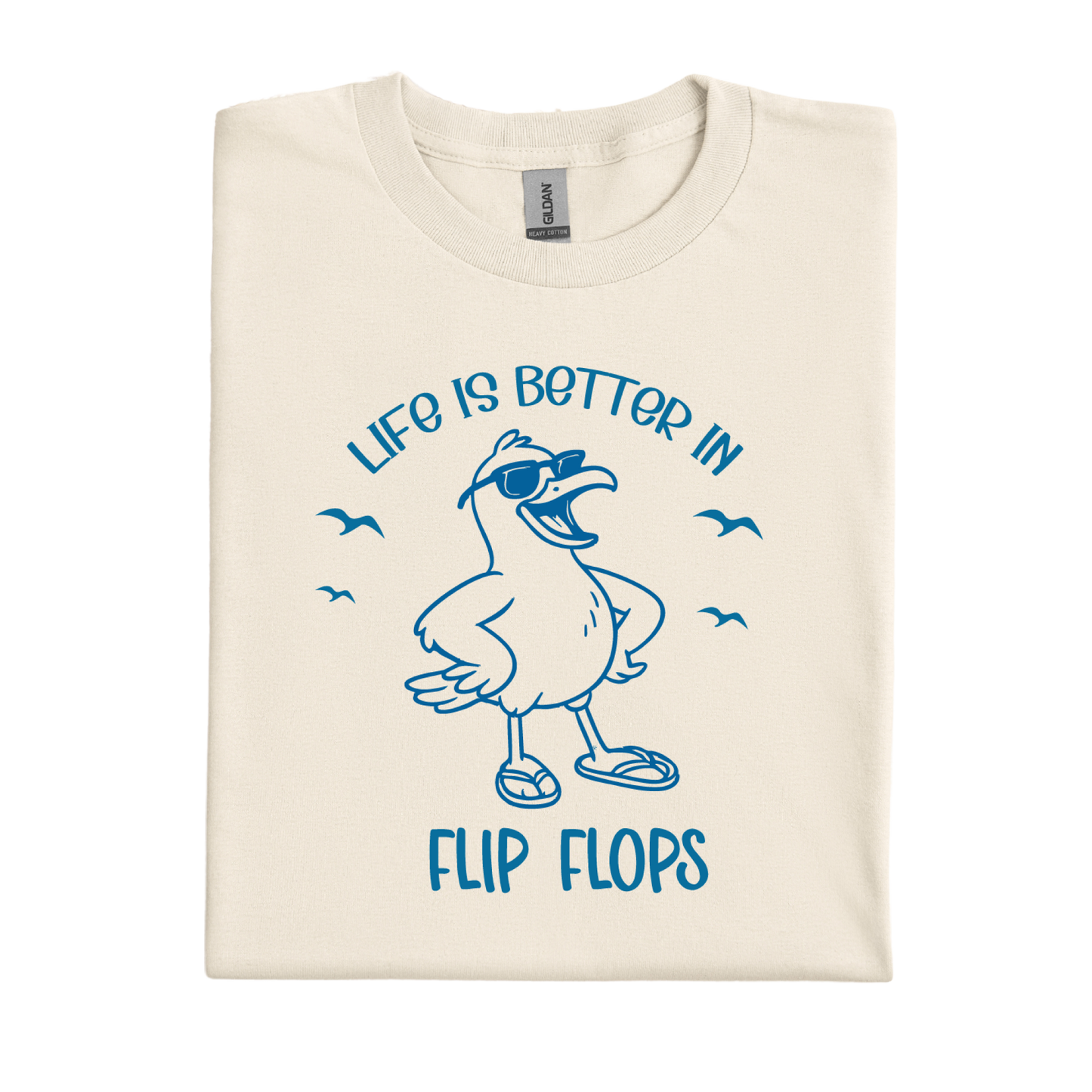 Folded t-shirt with a seagull graphic and text 'Life is better in flip flops' on a white background