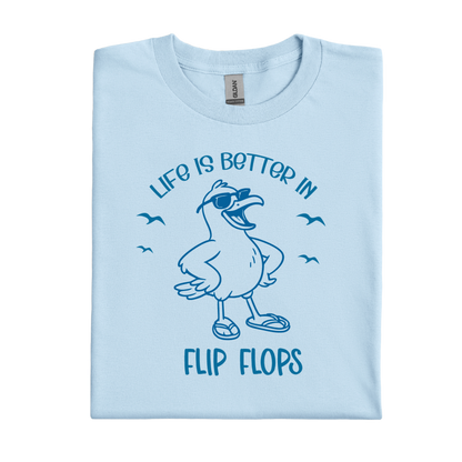 Light blue t-shirt with a cartoon seagull and text 'Life is better in flip flops' on a white background