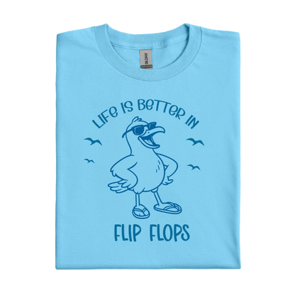 Sky blue t-shirt with a seagull graphic and text 'Life is better in flip flops' on a white background