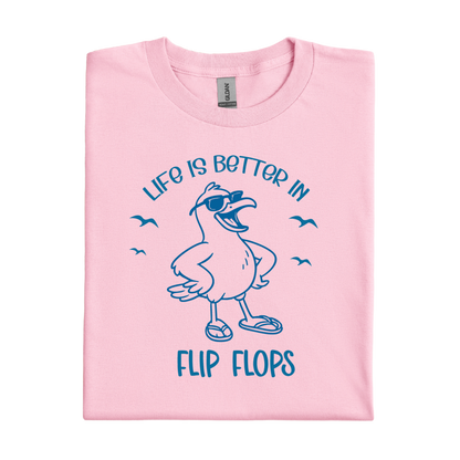 Light Pink t-shirt with blue seagull graphic and text 'Life is better in flip flops' on a white background