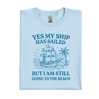 Light blue t-shirt with a ship and beach graphic and text on a white background