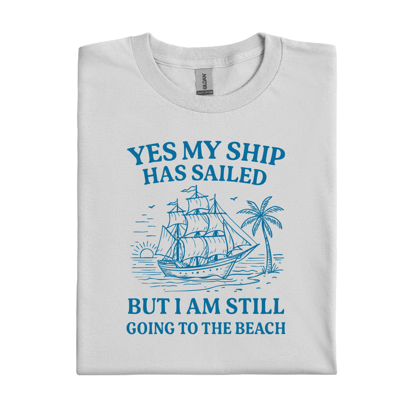 Folded t-shirt with blue ship and beach graphic and text on a white background