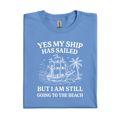 Carolina Blue t-shirt with white graphic and text 'YES MY SHIP HAS SAILED BUT I AM STILL GOING TO THE BEACH' on a white background
