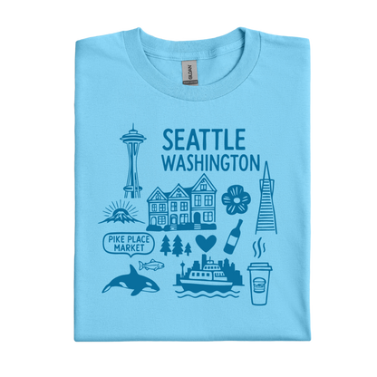 Sky blue t-shirt with Seattle-themed graphics and text on a white background