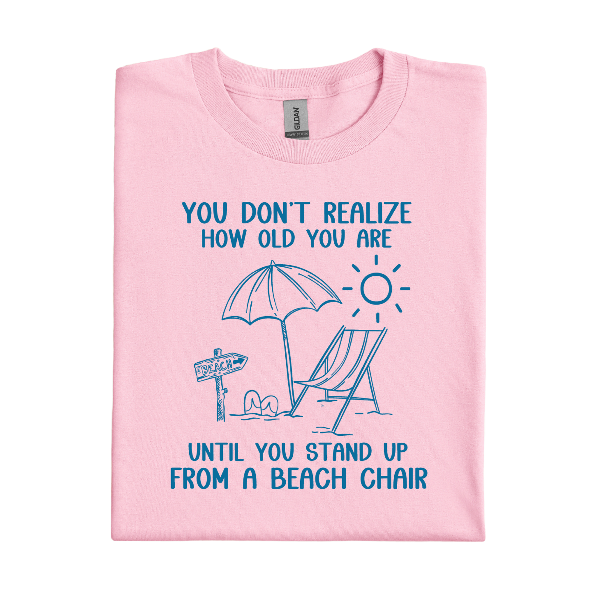 Pink t-shirt with beach-themed design and text on a white background