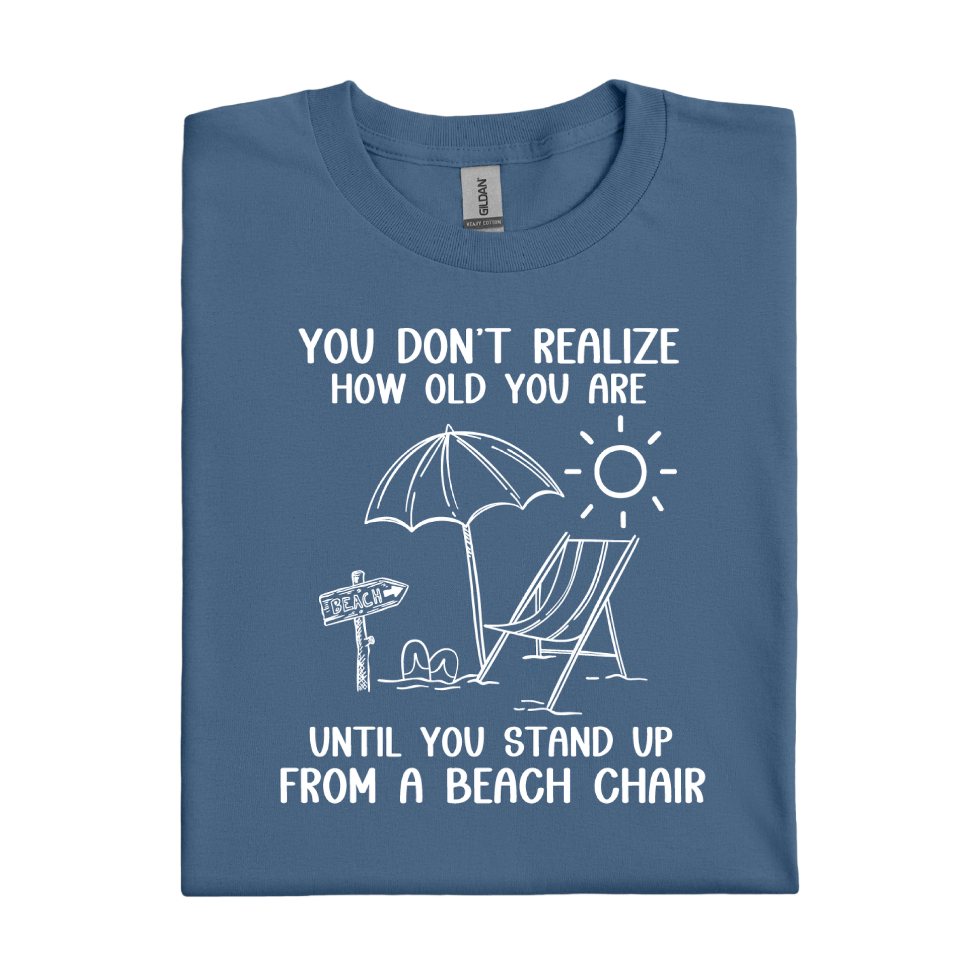 Folded indigo blue t-shirt with beach-themed graphic and text on a white background