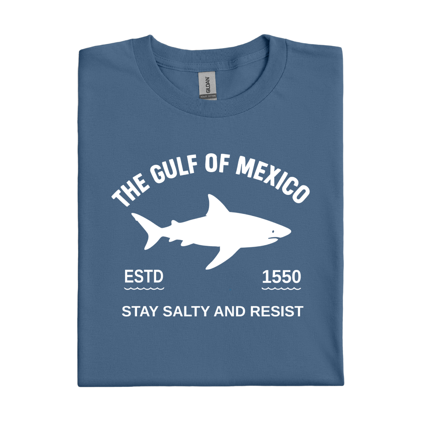 Folded indigo blue t-shirt with white shark graphic and text on a white background