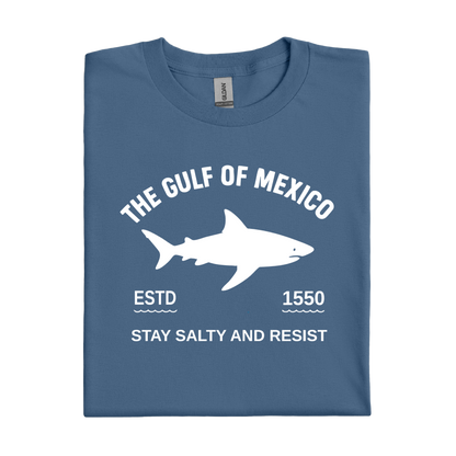 Folded indigo blue t-shirt with white shark graphic and text on a white background