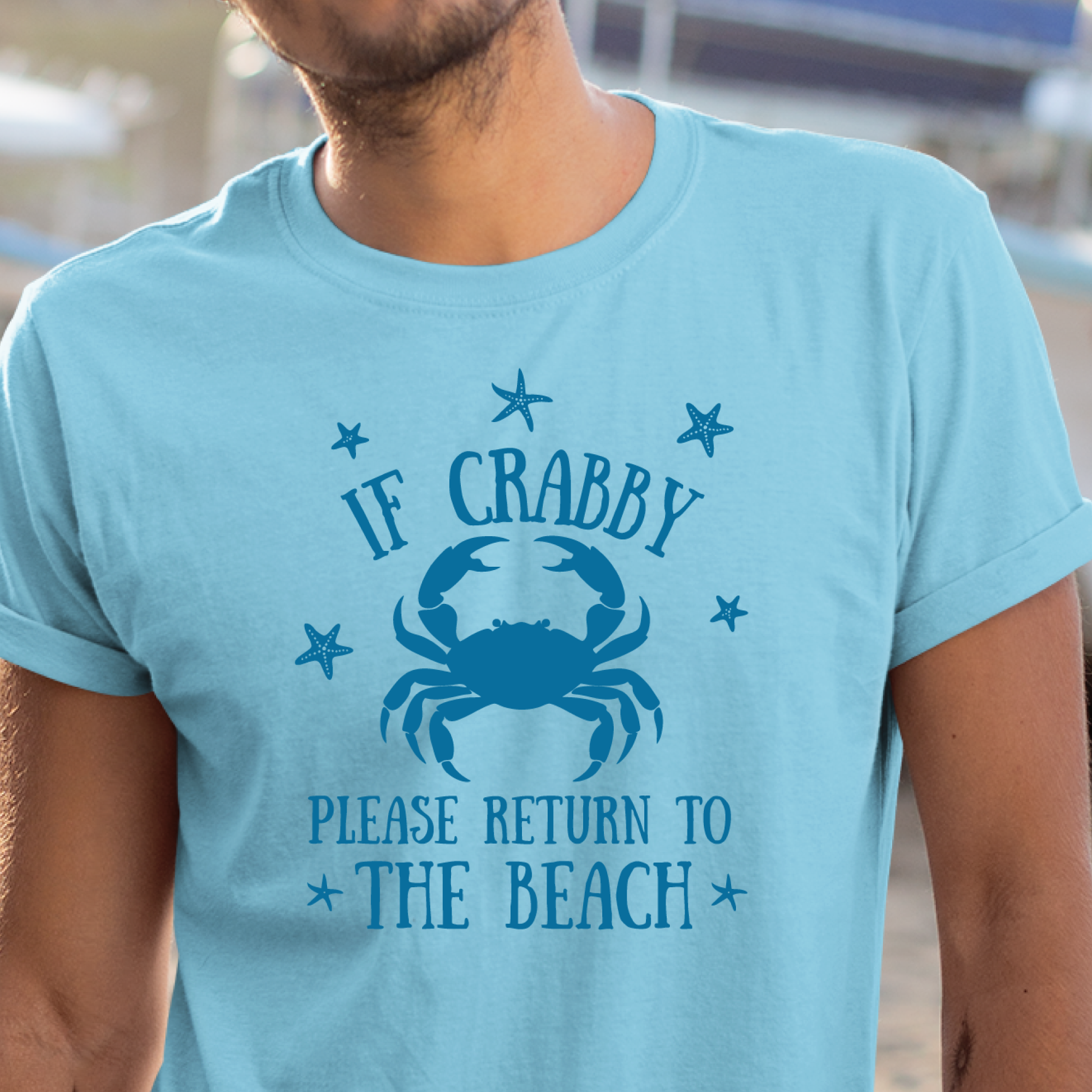 Sky blue t-shirt with a crab graphic and text worn by a person.
