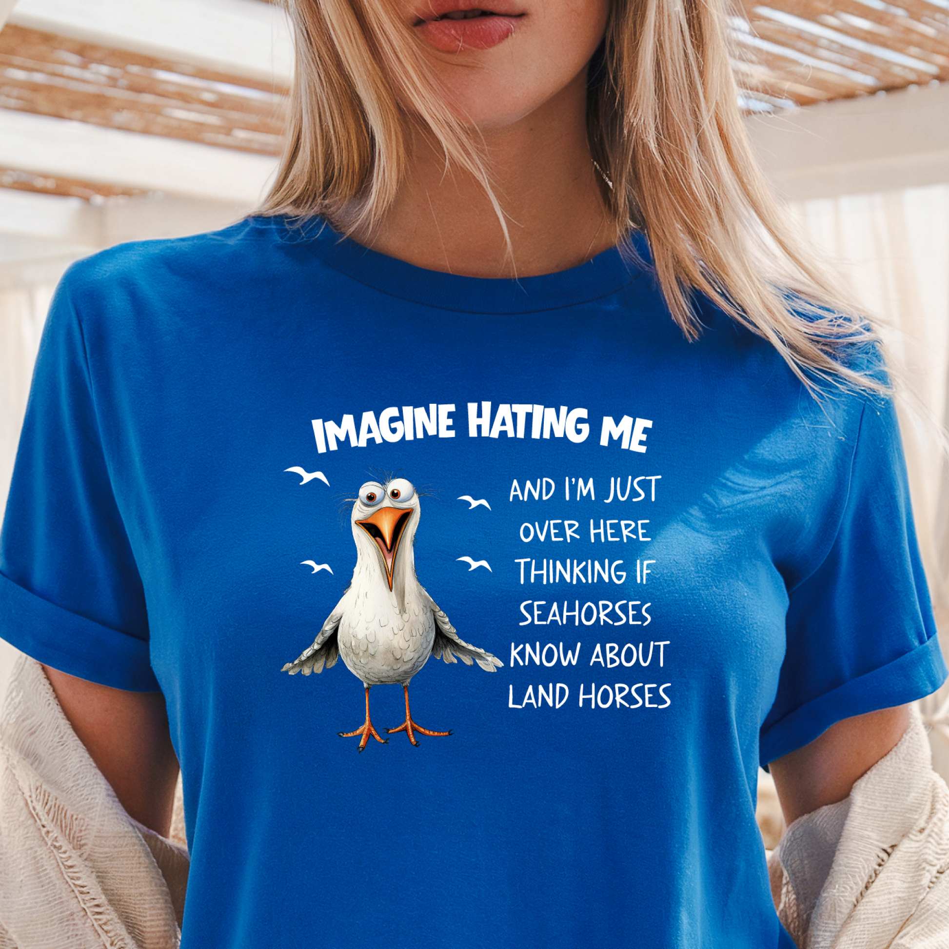 Person wearing a Royal blue t-shirt with a cartoon penguin and humorous text.