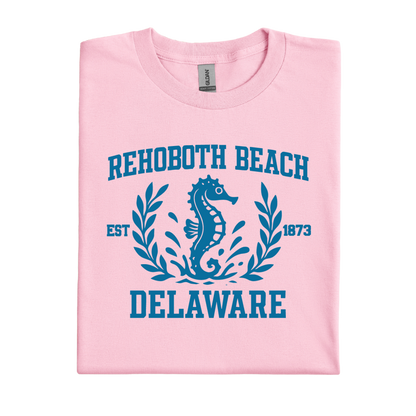 Pink t-shirt with blue seahorse design and text on a white background