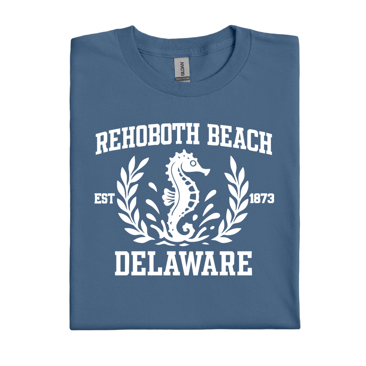 Folded indigo blue t-shirt with white text and seahorse design on a white background