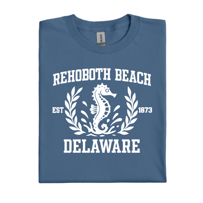 Folded indigo blue t-shirt with white text and seahorse design on a white background