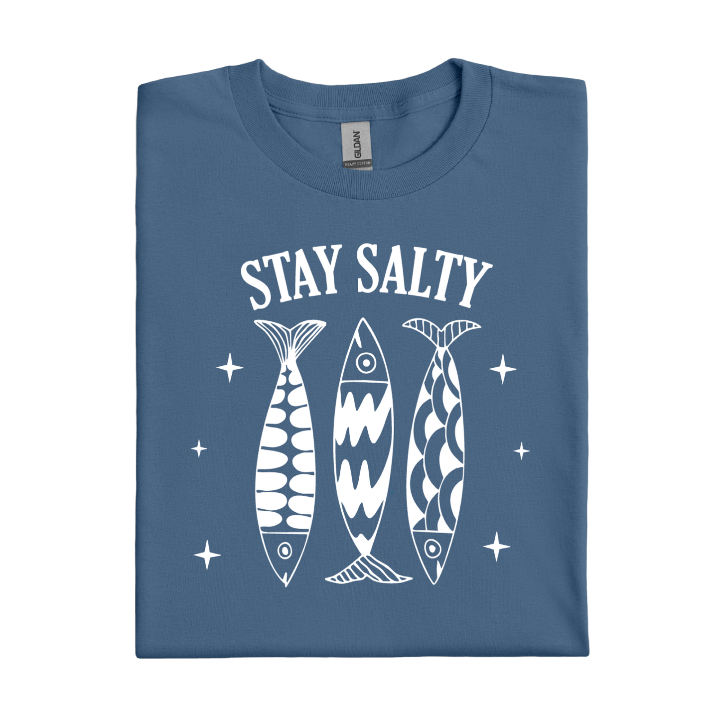 Folded indigo blue t-shirt with 'Stay Salty' text and fish graphics on a white background