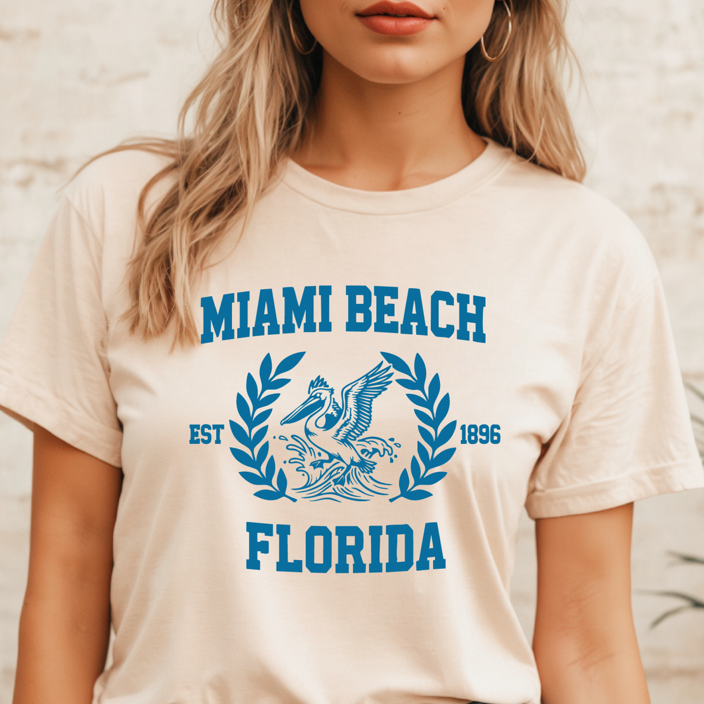 Person wearing a t-shirt with 'Miami Beach, Florida' design.