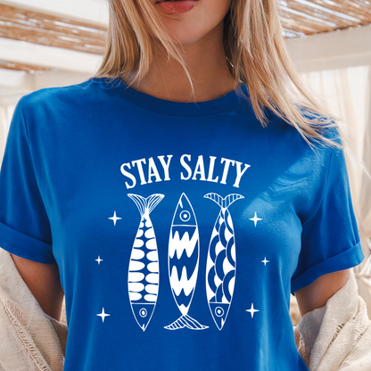 Person wearing a royal blue t-shirt with 'Stay Salty' text and fish graphics.
