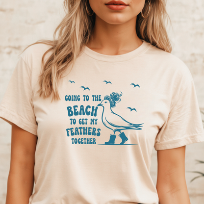 Person wearing a t-shirt with a blue graphic and text on a beige background