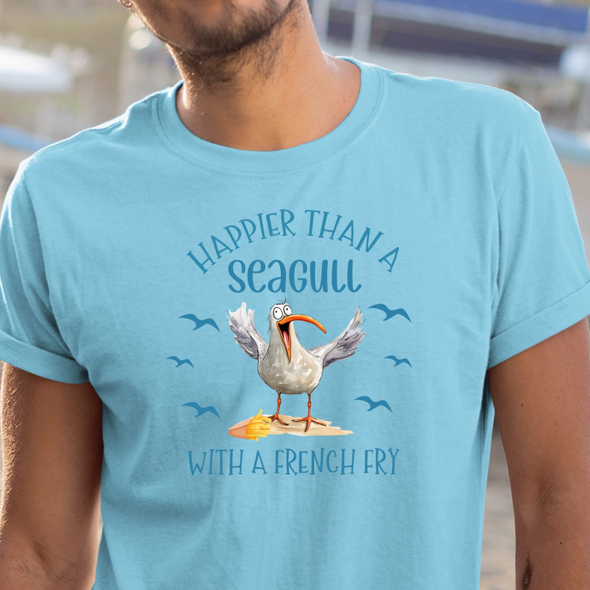 Person wearing a sky blue t-shirt with a seagull graphic and text.