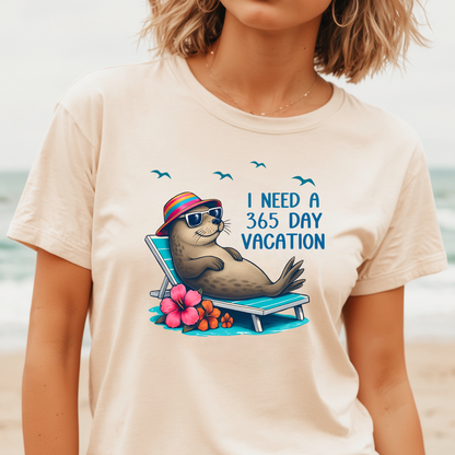 Person wearing a t-shirt with a seal graphic and text on a beach.
