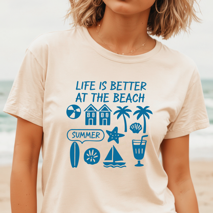 Person wearing a t-shirt with beach-themed graphics and text at the beach.