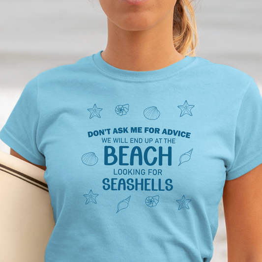 Person wearing a sky blue t-shirt with beach-themed text and graphics.