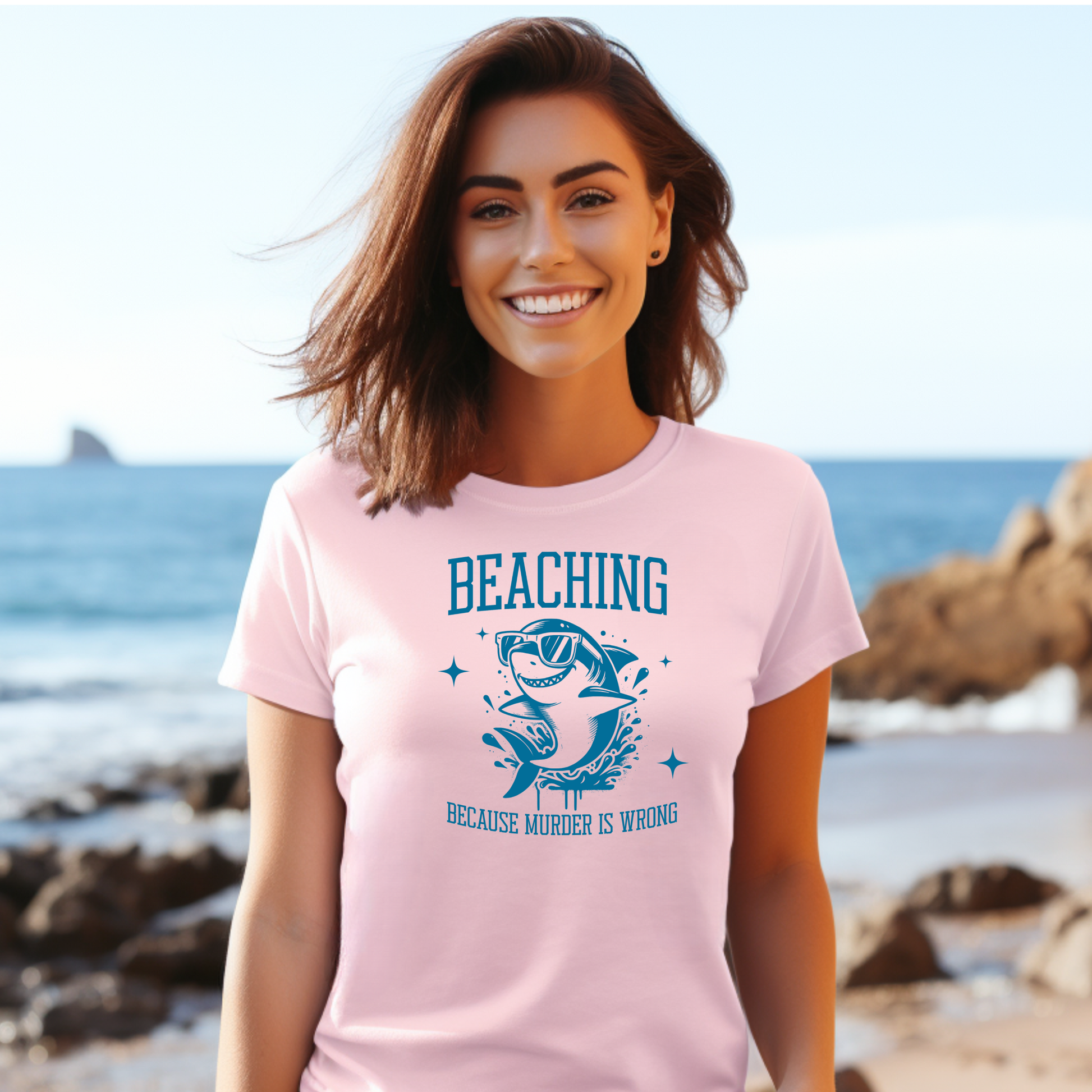 Gildan 5000 "Beaching Because Murder Is Wrong" t shirt with a funny shark with sunglasses jumping out of water in one color graphics. Picture of a girl standing on the beach wearing a t shirt.