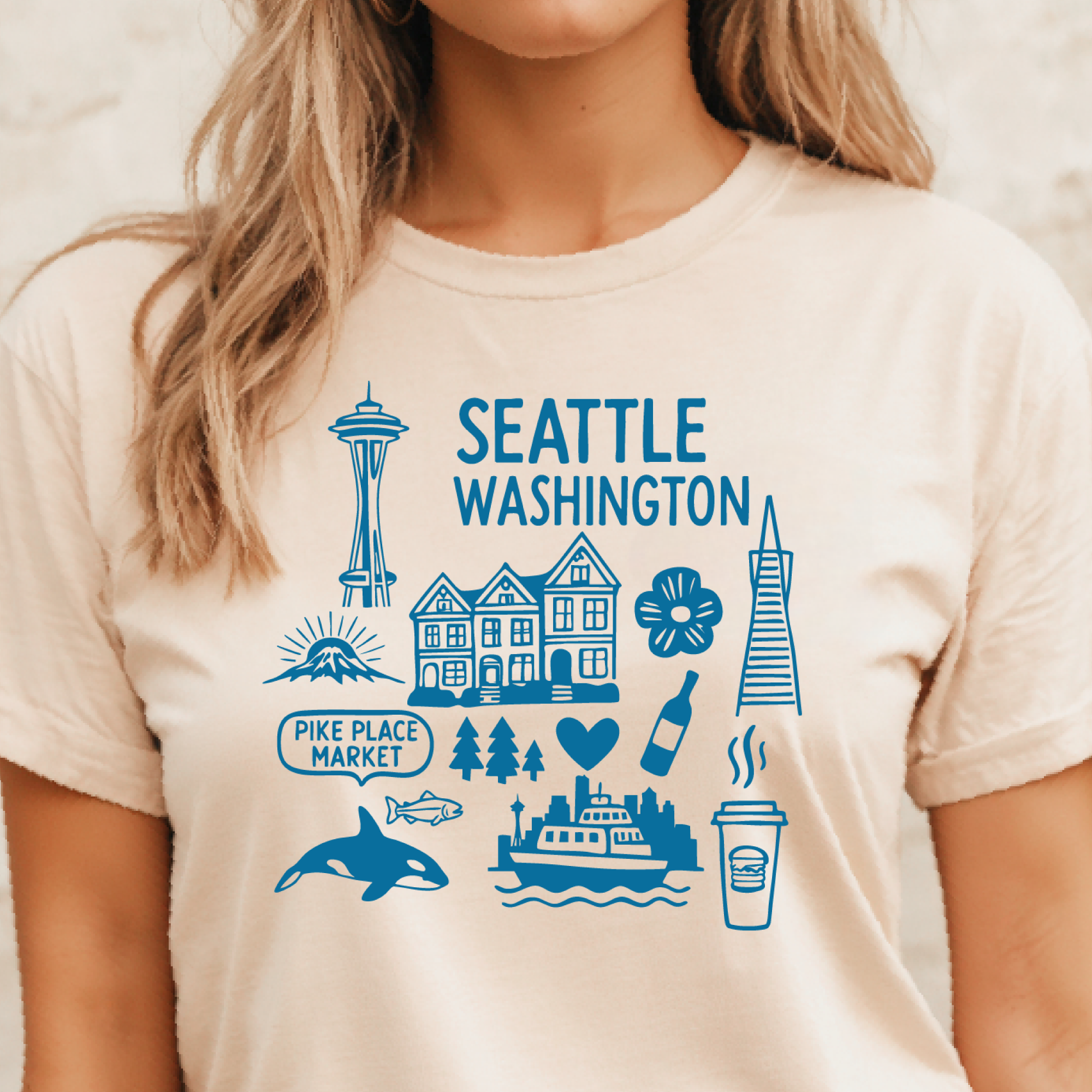 Person wearing a t-shirt with Seattle-themed graphics and text.