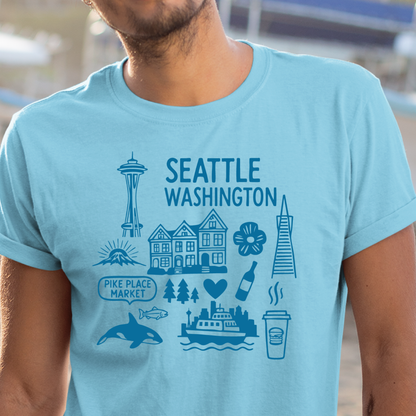 Sky blue t-shirt with Seattle-themed graphics and text worn by a person.