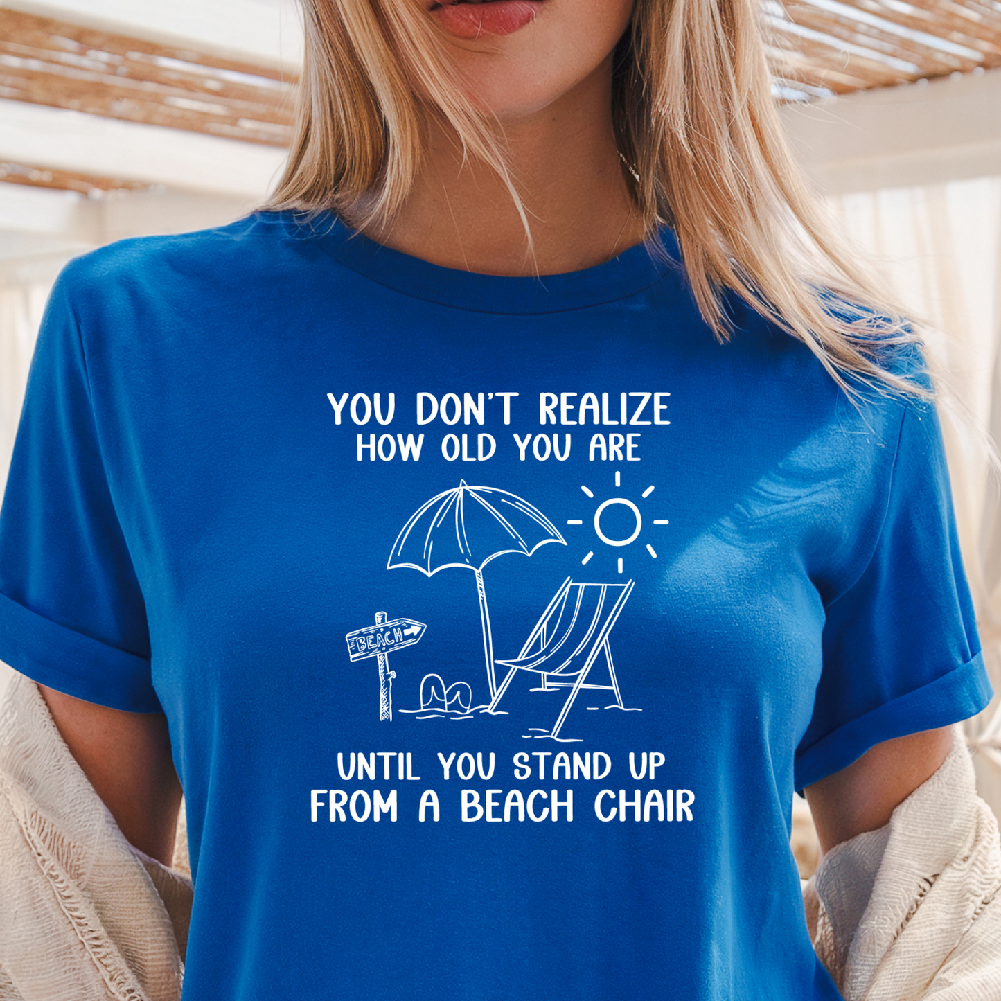 Person wearing a blue t-shirt with a humorous graphic and text.