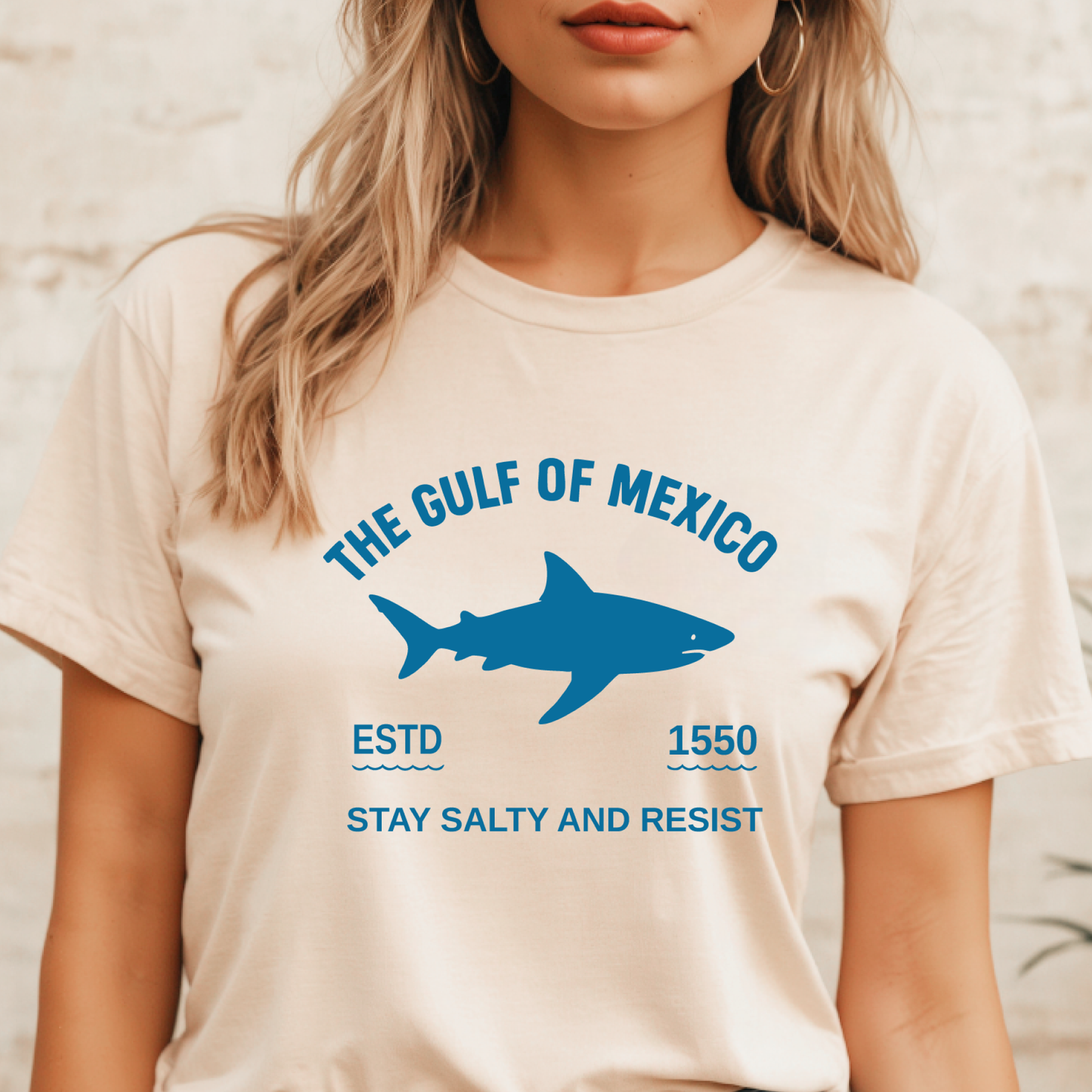 Person wearing a t-shirt with a shark graphic and text about the Gulf of Mexico.