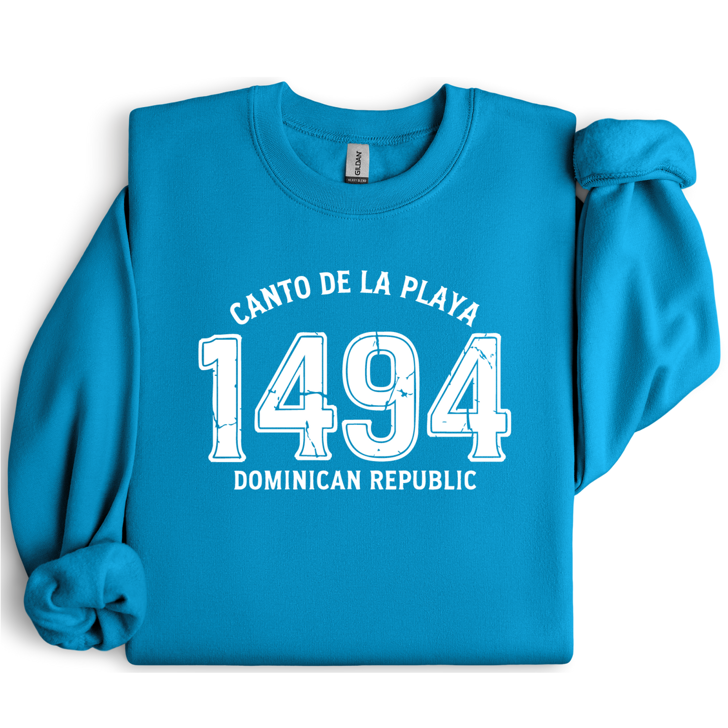 Gildan sweatshirt with “Canto De La Playa 1494 Dominican Republic” printed in distressed navy text. Vintage beach-inspired crewneck symbolizing Caribbean heritage and coastal charm. Made from soft cotton-poly blend fabric for comfort and style, ideal for beach lovers and travelers who adore Dominican culture. Cozy, sustainable, and perfect for casual wear or tropical getaways.