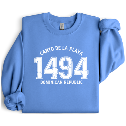 Gildan sweatshirt with “Canto De La Playa 1494 Dominican Republic” printed in distressed navy text. Vintage beach-inspired crewneck symbolizing Caribbean heritage and coastal charm. Made from soft cotton-poly blend fabric for comfort and style, ideal for beach lovers and travelers who adore Dominican culture. Cozy, sustainable, and perfect for casual wear or tropical getaways.