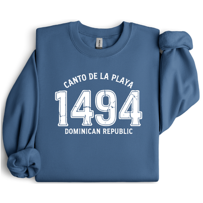 Gildan sweatshirt with “Canto De La Playa 1494 Dominican Republic” printed in distressed navy text. Vintage beach-inspired crewneck symbolizing Caribbean heritage and coastal charm. Made from soft cotton-poly blend fabric for comfort and style, ideal for beach lovers and travelers who adore Dominican culture. Cozy, sustainable, and perfect for casual wear or tropical getaways.
